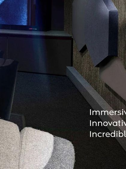 A closer look at the design elements of our "Entertainment Reimagined" concept. Notice the textured wall panels for acoustic treatment, the precise placement of recessed ceiling lights, and the comfortable, fabric-upholstered cinema seats.