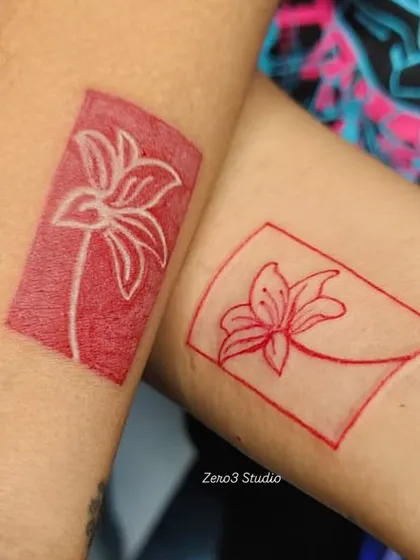 A closer look at the red ink couple tattoos. The negative space design on one arm and the line-art on the other create a perfect pair.