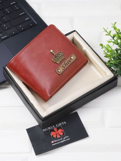 A rich red leather wallet personalized with a crown charm, shown in its gift box, ready for any special occasion.
