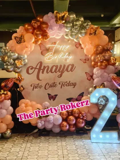 Another angle of the "Two Cute Today" party, showing the full balloon arch and the placement of the marquee number and balloon pillars. This setup is perfect for restaurant or banquet hall parties.