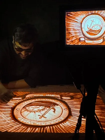 This shot captures me at work on the Eastern Naval Command crest, with the live projection visible on the monitor. It shows the live performance setup for these high-stakes events, where precision and emotion must come together seamlessly.