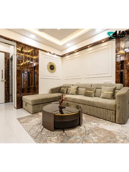 This living room in Bhiwandi features rich, dark wood tones contrasted with light-colored upholstery. Mirrored panels on the walls and doors add a touch of glamour and help to reflect light throughout the space.