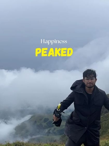Happiness is reaching the peak. A trekker enjoying the cloudy, magnificent views from the top of Kudremukha.