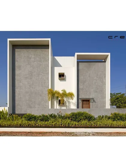 The rear elevation of the 'Framed House,' showcasing two parallel, monolithic volumes. This composition of simple, powerful forms is a hallmark of our minimalist design approach.