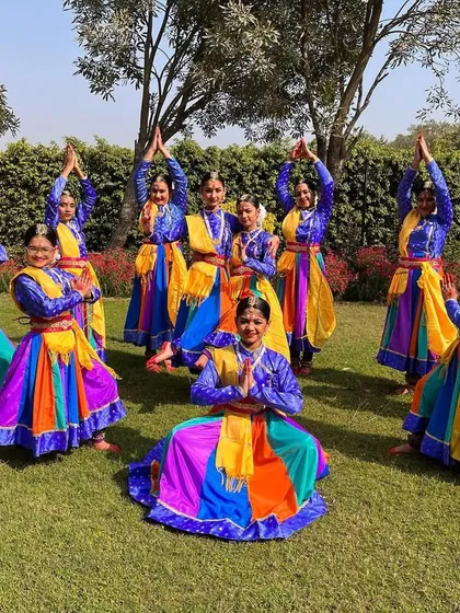 The final pose of a beautiful outdoor performance. The colorful costumes and synchronized postures create a stunning visual.