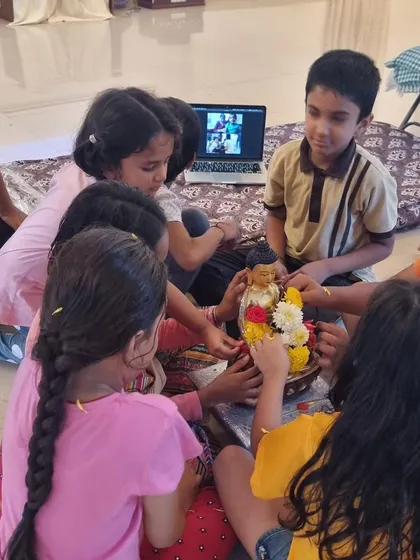 The children gathered to decorate the new Buddha statue, some joining online. It was a beautiful moment of shared community and a reminder to wish for peace for all beings.