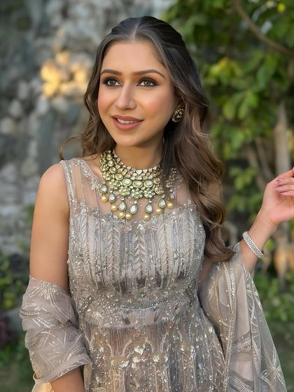 A happy and radiant client, her makeup looking fresh and perfect for the occasion.