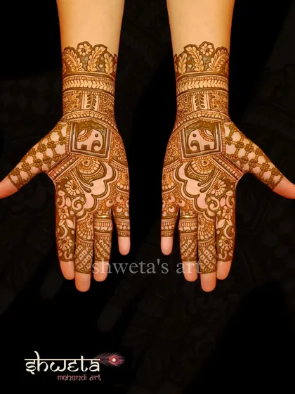 A simple and elegant design for the hands. It features a central elephant motif within a square frame, surrounded by delicate patterns that are perfect for a wedding guest.