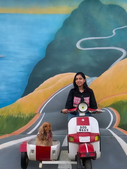 Posing with the iconic scooter at a pet-friendly cafe. Posto is the perfect sidecar companion.