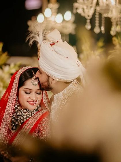A tender moment between the couple after their wedding ceremony. The groom’s gentle kiss on the bride’s forehead is a classic expression of love and care that we love to capture.