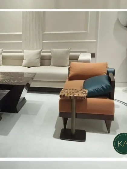 An eclectic living room arrangement featuring an orange armchair with a patterned side table and a neutral-toned sofa. This shows our versatility in combining different styles and colors to match a client's vision.