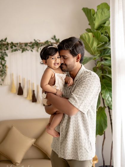 A father and daughter share a sweet, cuddly moment. The love between them is so clear.