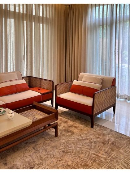 The seating arrangement in the Palm Springs Villa features a mix of materials, including cane and wood. This combination adds texture and a touch of classic elegance to the modern interior design scheme.