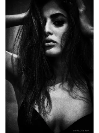The absolutely gorgeous Priya Banerjee. This high-contrast, grainy black and white portrait has a raw, intense, and cinematic feel.