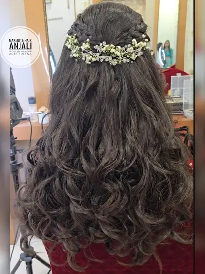 A romantic hairstyle for an engagement look. My artist Anjali created this half-up braided style with soft curls and a delicate baby's breath hairpiece.