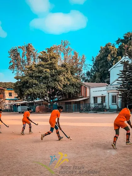 The heart of hockey is born on grounds like this. A line of our young players at a summer camp, practicing their dribbling, perfectly captures the focus and dedication we instill from day one.