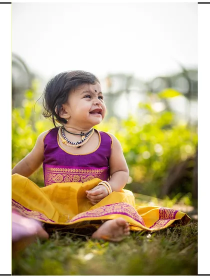 A beautiful, happy moment captured outdoors. The genuine laughter of a child is always the best part of any photoshoot.