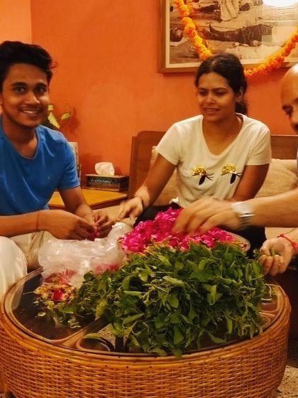 Our community members joyfully preparing flowers and sacred leaves for the Maha Mrityunjaya Homa, a beautiful act of selfless service (seva).