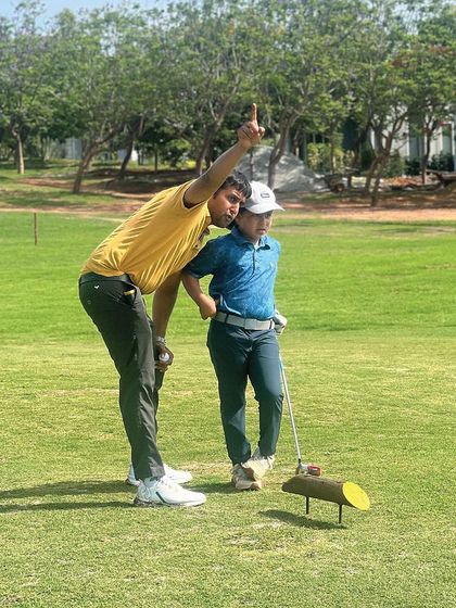 A coach giving a young player some last-minute advice before his round. Mentorship is key, especially in a competitive setting.