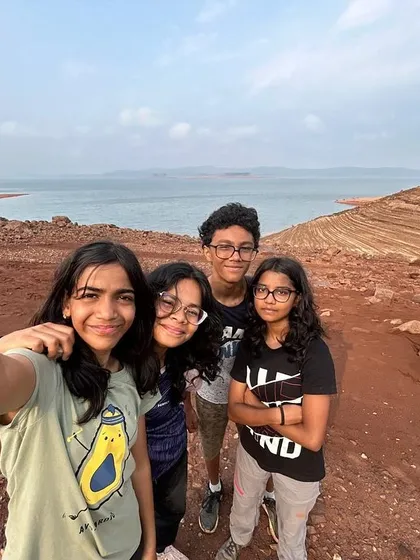 A selfie captures a group of new friends against the backdrop of the vast reservoir near Dandeli.