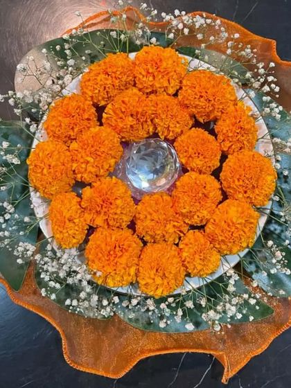 A simple yet beautiful centerpiece made with a plate of bright orange marigolds and baby's breath. This is an easy DIY idea that adds a wonderful pop of color and festive charm to any table.