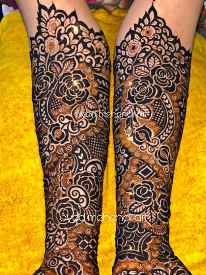A close-up of the arms from a full bridal design, showing the symmetrical and dense patterns.