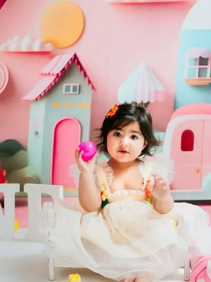 A calmer moment during the city-themed shoot. She sits sweetly amidst the colorful props, giving a lovely, gentle portrait.
