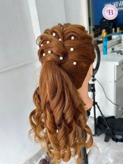 A photo of a beautiful high ponytail with curls and pearl accessories, created on a mannequin to showcase hairstyling skills.