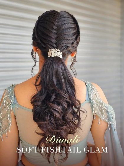 For the main Diwali celebration, this soft fishtail glam ponytail is a showstopper. The intricate braid is paired with soft curls, creating a look that is both glamorous and comfortable.