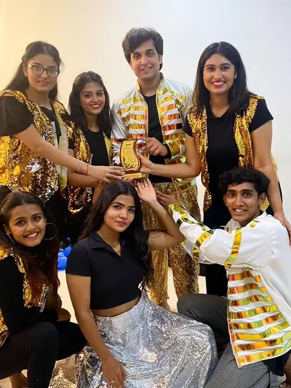 Happy faces and a trophy in hand! This is my award-winning dance troupe after a powerful Bollywood performance. When you book us, you're not just getting dancers, you're getting a team that brings home the gold.