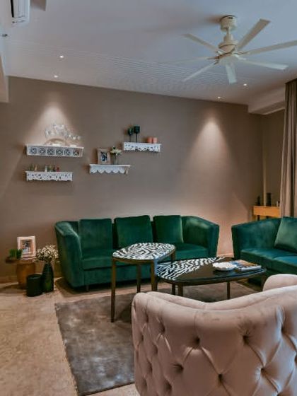 A vibrant play on color defines this living room. Shades of grape in high-gloss and matte finishes create drama, while a calming beige wallpaper provides balance for a space brimming with artistic energy.