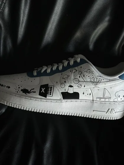 A side profile of the other shoe in the doodle custom pair.