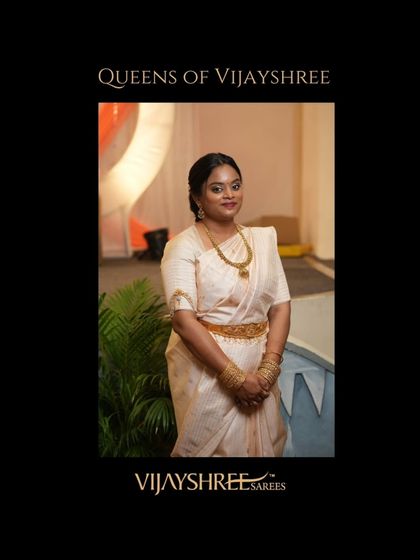 Anusha glowing at a ceremony in her hand-picked off-white Kanjivaram with subtle gold stripes.