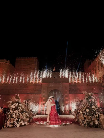 A moment suspended in time. Against the majestic backdrop of Suryagarh, we framed the couple's union with a symphony of light and fireworks, creating a magical embrace that sealed their love story forever.
