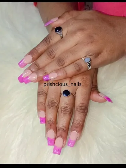 A fun twist on the French manicure with a vibrant pink marble effect on the tips of these long, square acrylics.