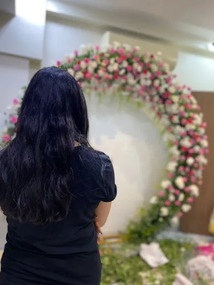 A client admiring the fresh floral ring we are creating for her home Roka ceremony. I love bringing these beautiful visions to life.