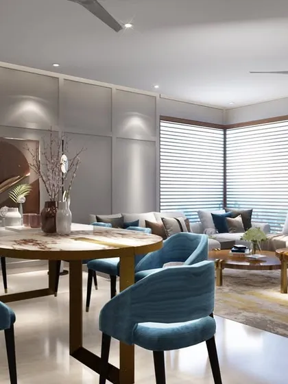 Another view of the cozy living and dining area, where plush blue chairs add a pop of color. The design focuses on creating a comfortable and inviting atmosphere for the family.