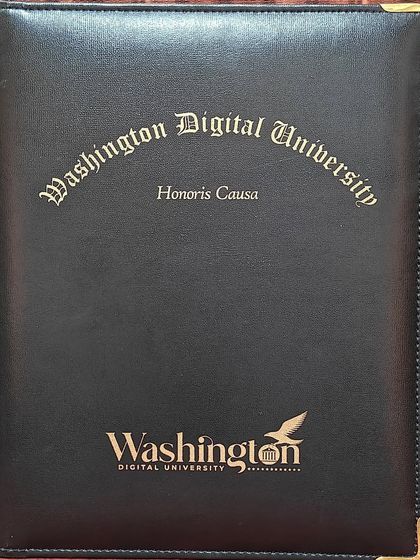 The official folder from Washington Digital University for the Honoris Causa degree, a symbol of this significant milestone.