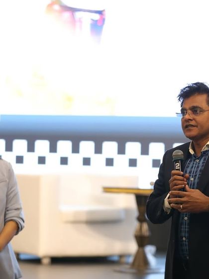 Sharing a lighthearted moment on stage with a participant. As an anchor, I create a comfortable environment for everyone to express themselves.