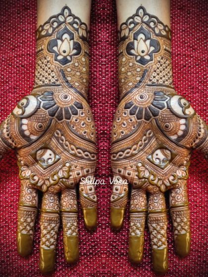 A very full and intricate design featuring elephants and lotuses, with bold, dark shading for a dramatic effect.