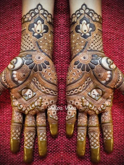A very full and intricate design featuring elephants and lotuses, with bold, dark shading for a dramatic effect.