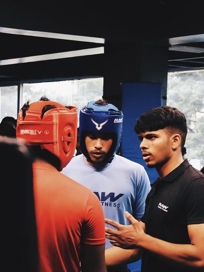A coach gives last minute advice to his fighters before a match. This corner talk is vital for strategy, motivation, and keeping a fighter focused under pressure.