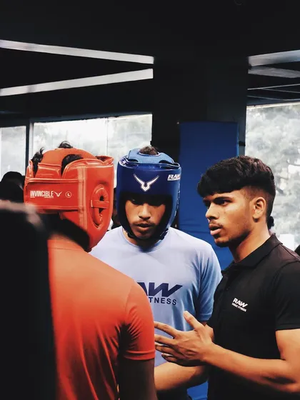A coach gives last-minute advice to his fighters before they step into the ring.