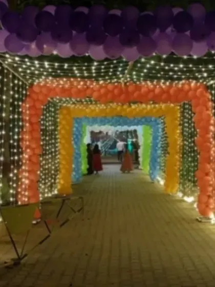 Making a grand entrance with this immersive rainbow balloon tunnel. Lined with sparkling fairy lights, this archway creates a magical pathway for guests, perfect for an evening reception or a fun-themed party.