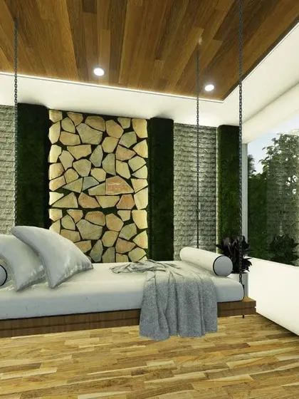 A close-up of a custom-designed covered balcony with a hanging swing bed. This feature turns an ordinary balcony into a personal retreat, blending natural materials like wood and stone with the comfort of an indoor living space.