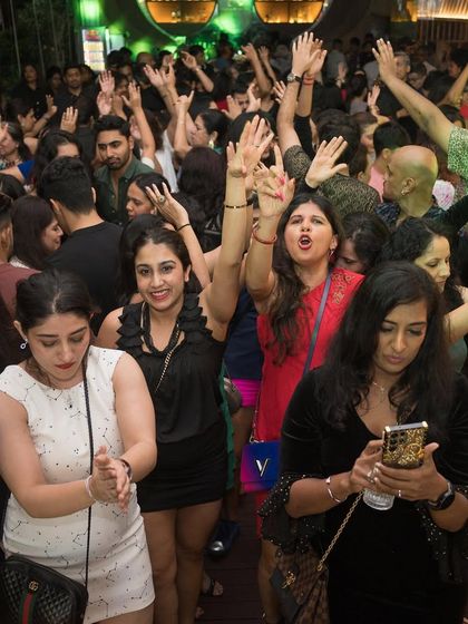 The crowd at Badmaash with their hands up, ready to party.