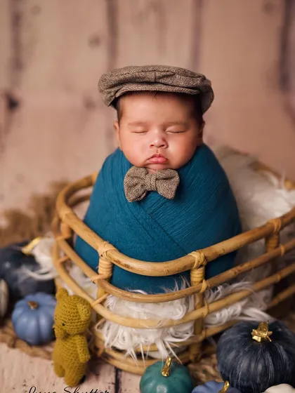 A little gentleman in the making, this portrait features a stylish flat cap to complete the adorable look.