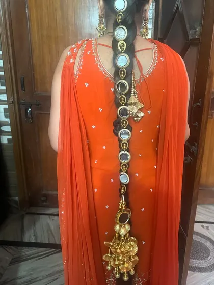 A full back view of the parandi braided into the hair, showing its length and the beautiful tassel at the end.