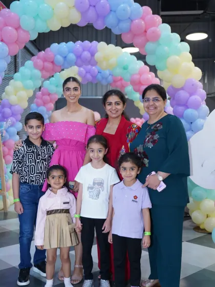 A lovely group photo under a pastel balloon arch. Wobble World is the perfect place for friends and family to gather and celebrate special milestones together.
