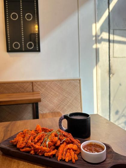 Pork Bhujia, a famous bar snack from Nagaland, is the perfect starter. We serve these crispy, savory strips of pork with our homemade fermented rice drink for a classic Naga pairing.